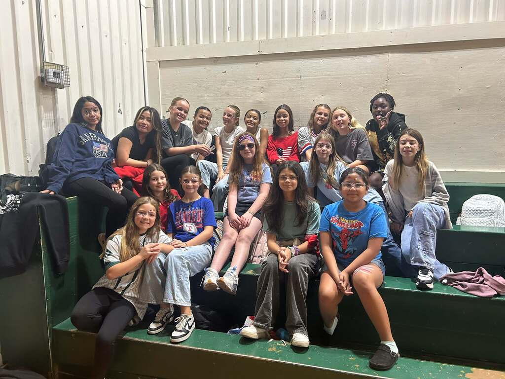 female students sitting together in the stands