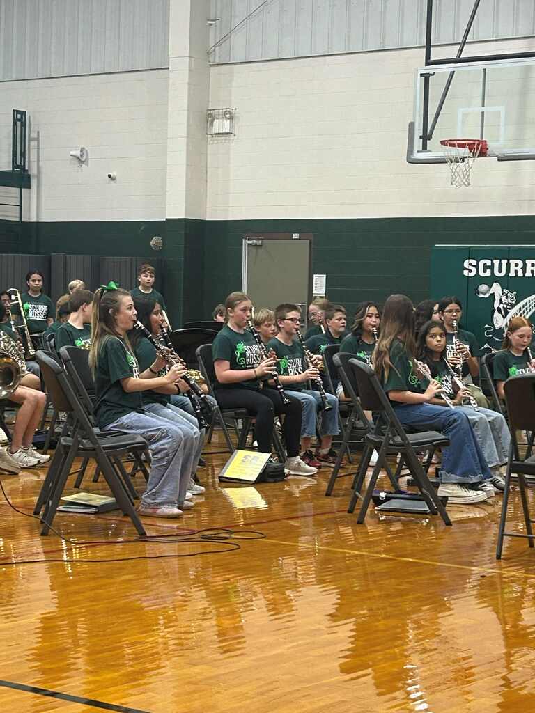 group of students playing their instrument in the gym