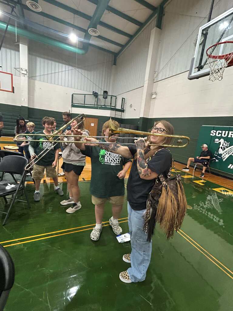parent playing instrument with student
