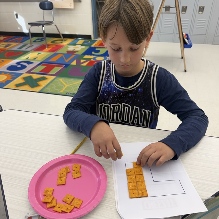 How many Cheez-its does it take to cover the area of a shape? Third graders are using cheez its to figure it out!