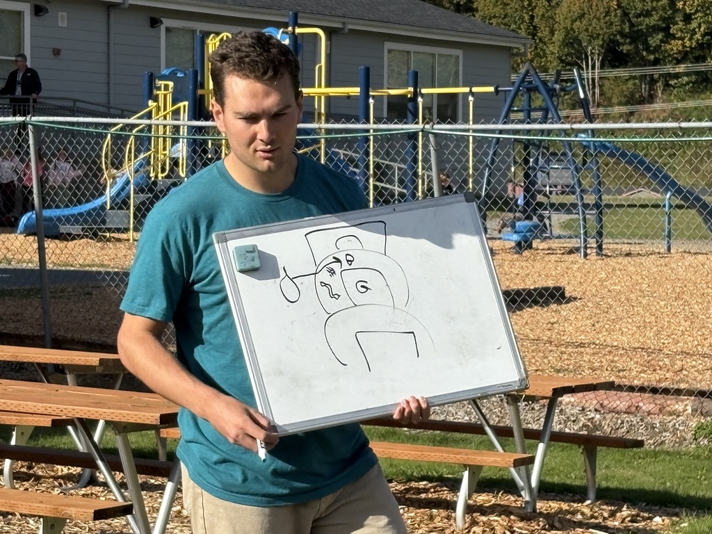 Students at Lyman Elementary participate in Farm to School lessons with instructor Miles Lane, learning about leaves and composting through hands-on garden activities.