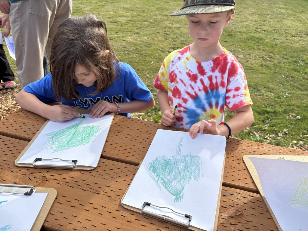 Students at Lyman Elementary participate in Farm to School lessons with instructor Miles Lane, learning about leaves and composting through hands-on garden activities.