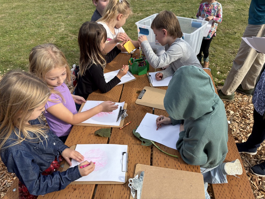 Students at Lyman Elementary participate in Farm to School lessons with instructor Miles Lane, learning about leaves and composting through hands-on garden activities.