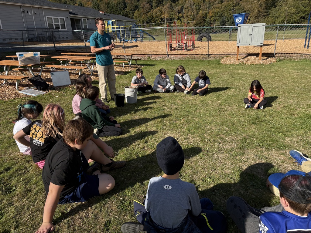 Students at Lyman Elementary participate in Farm to School lessons with instructor Miles Lane, learning about leaves and composting through hands-on garden activities.