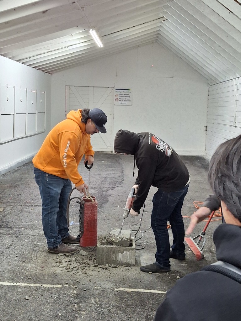 Students take turns using a jackhammer with supervision from LiUNA Northwest Laborers Training representatives.
