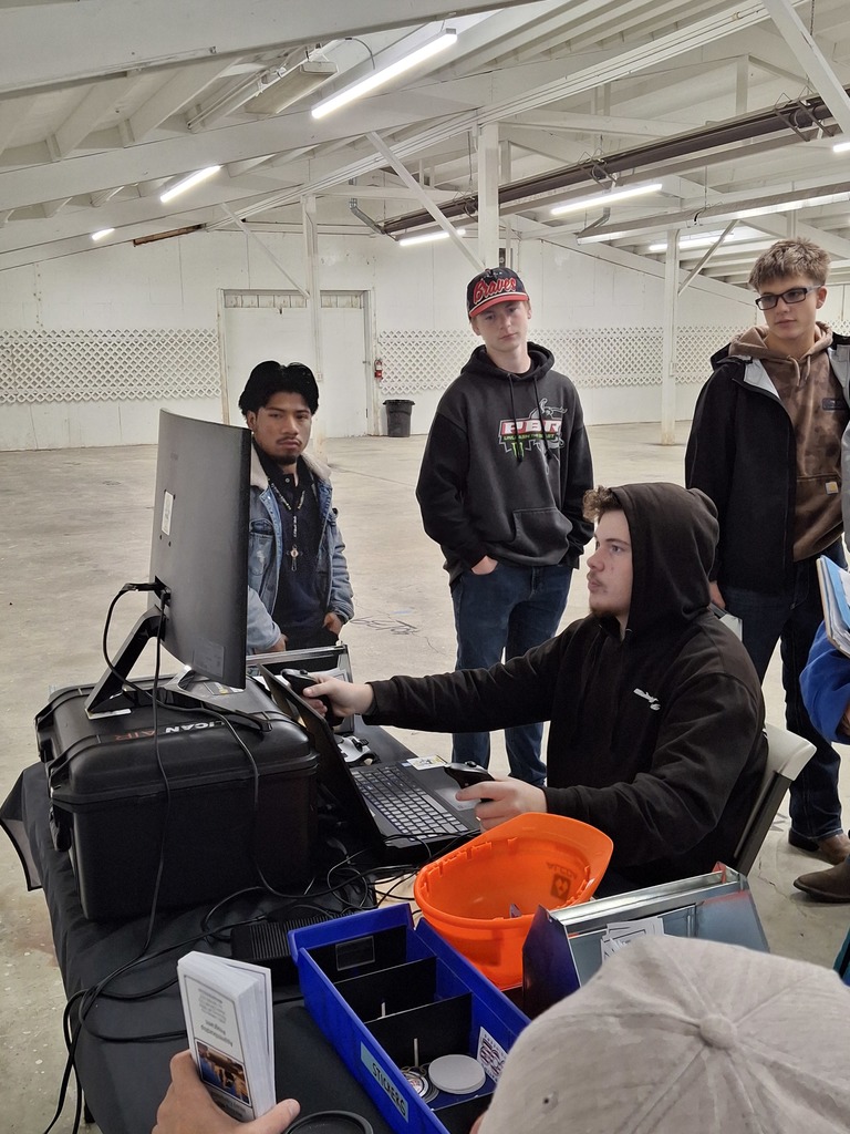 A student practices operating a backhoe under the guidance of instructors from the Operating Engineers Regional Training Program.