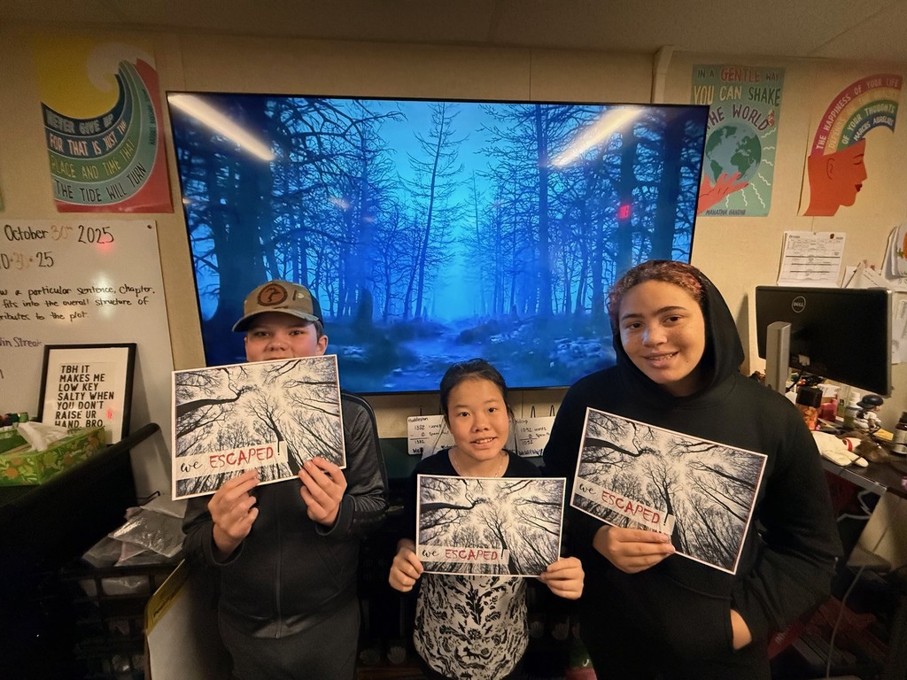 6th grade students work in small groups during a Halloween-themed classroom escape room challenge. Students are reading clues, solving puzzles, and discussing story elements together as part of a spooky ELA activity.