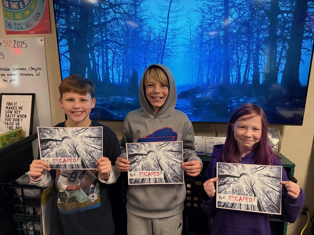 6th grade students work in small groups during a Halloween-themed classroom escape room challenge. Students are reading clues, solving puzzles, and discussing story elements together as part of a spooky ELA activity.
