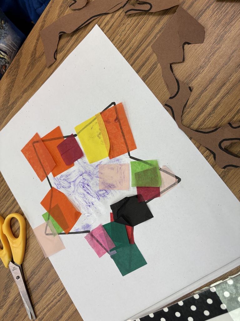 A stain glass being fashioned out of tissue paper. 