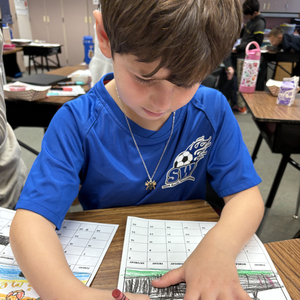 Third grade students at Central Elementary draw and color pictures of summer activities at their desks.
