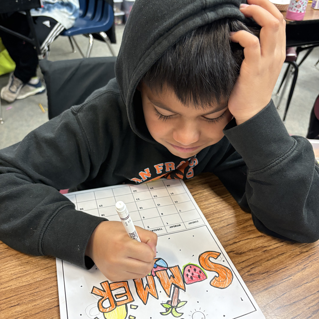 Third grade students at Central Elementary draw and color pictures of summer activities at their desks.