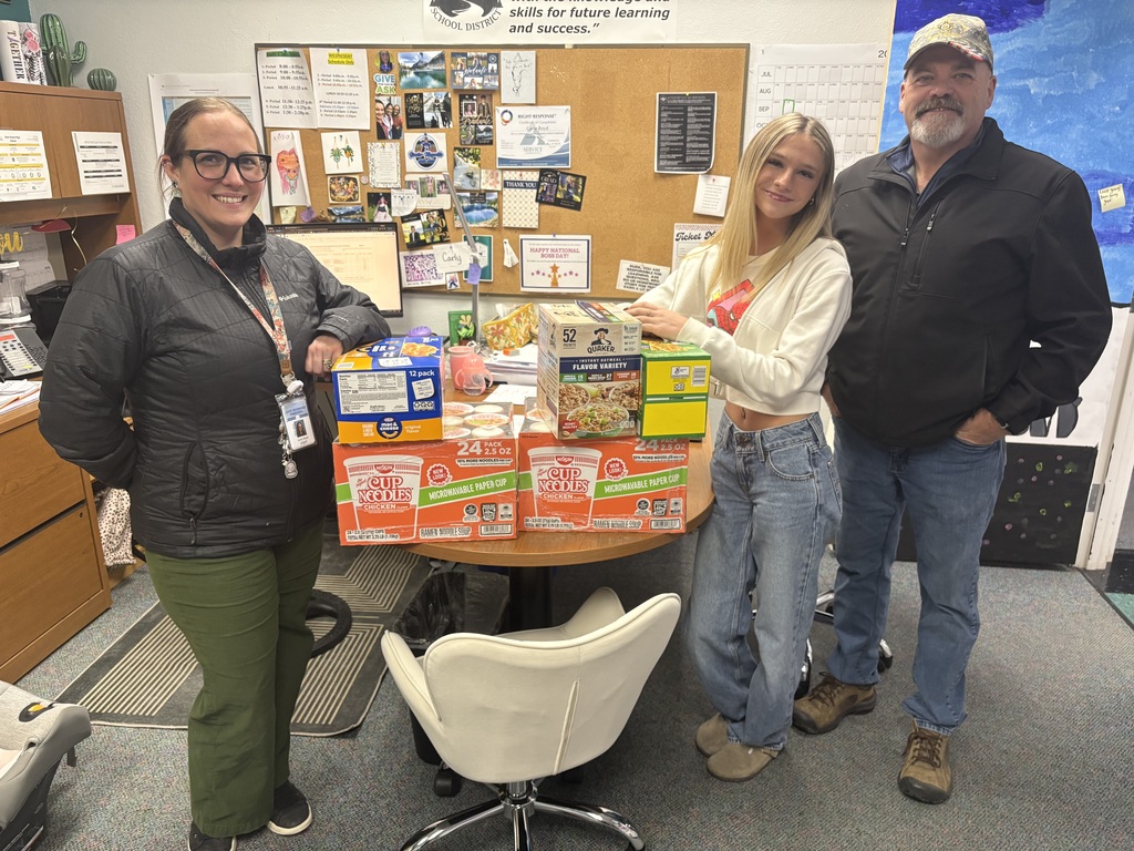 Dr. Carly Boyd with a student and Rotary Club President Lin Tucker with the donated food.