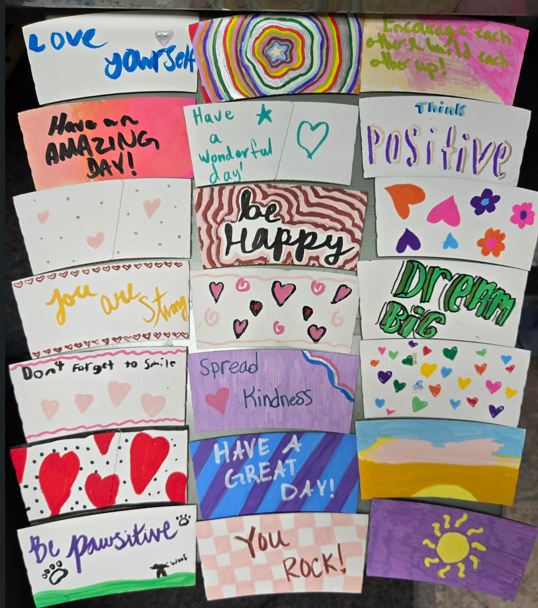 Sources of Strength Random Acts of Kindness Coffee Sleeves produced by Cascade students. 