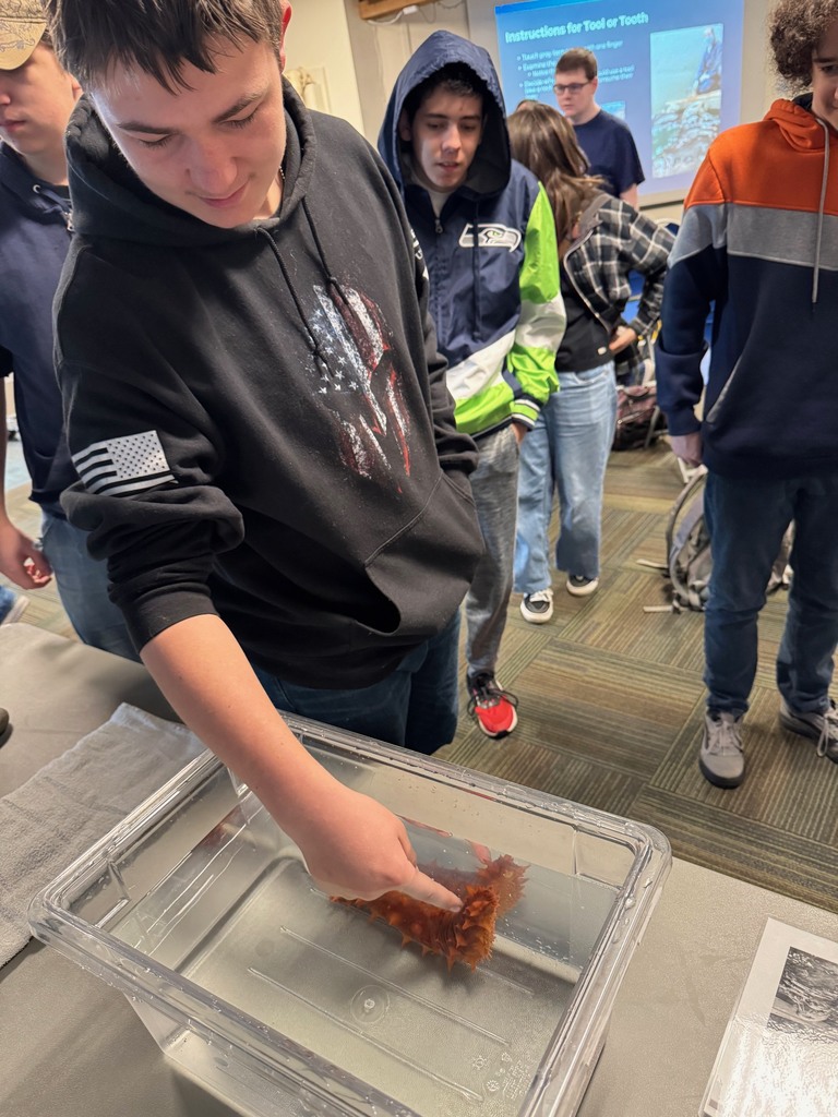 Students explore exhibits at the Seattle Aquarium while learning about ocean habitats and the role scientists play in protecting marine wildlife.