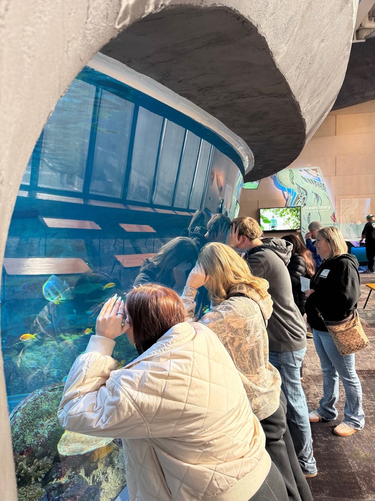 Students explore exhibits at the Seattle Aquarium while learning about ocean habitats and the role scientists play in protecting marine wildlife.