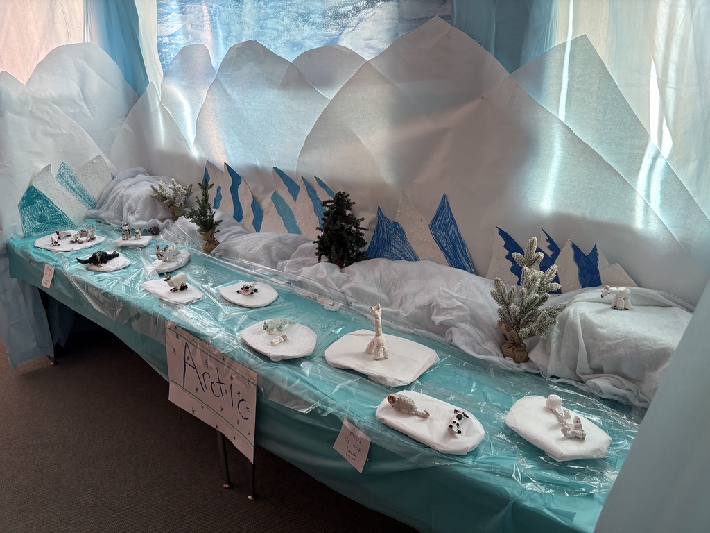 A student-built Arctic habitat display featuring snowy scenery and animal models, highlighting adaptations that help animals survive in cold, icy conditions.