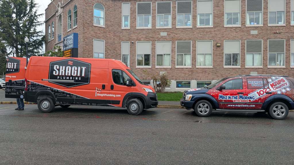 Skagit Plumbing and Mike in the Morning vehicles in front of Central.