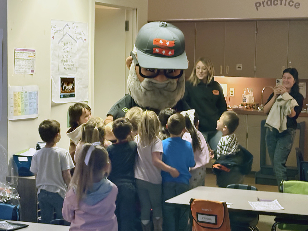 Students mob Mr. 360 for hugs. 