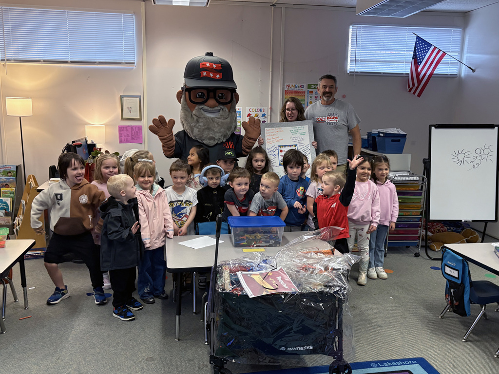 The class poses with Mr. 360. 