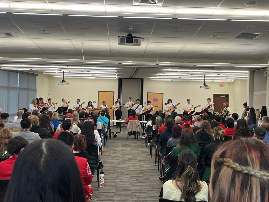 Sedro-Woolley High School mariachi students in performance attire at Central Washington University during the State Solo & Ensemble Music Competition, holding instruments and smiling together during their performance.