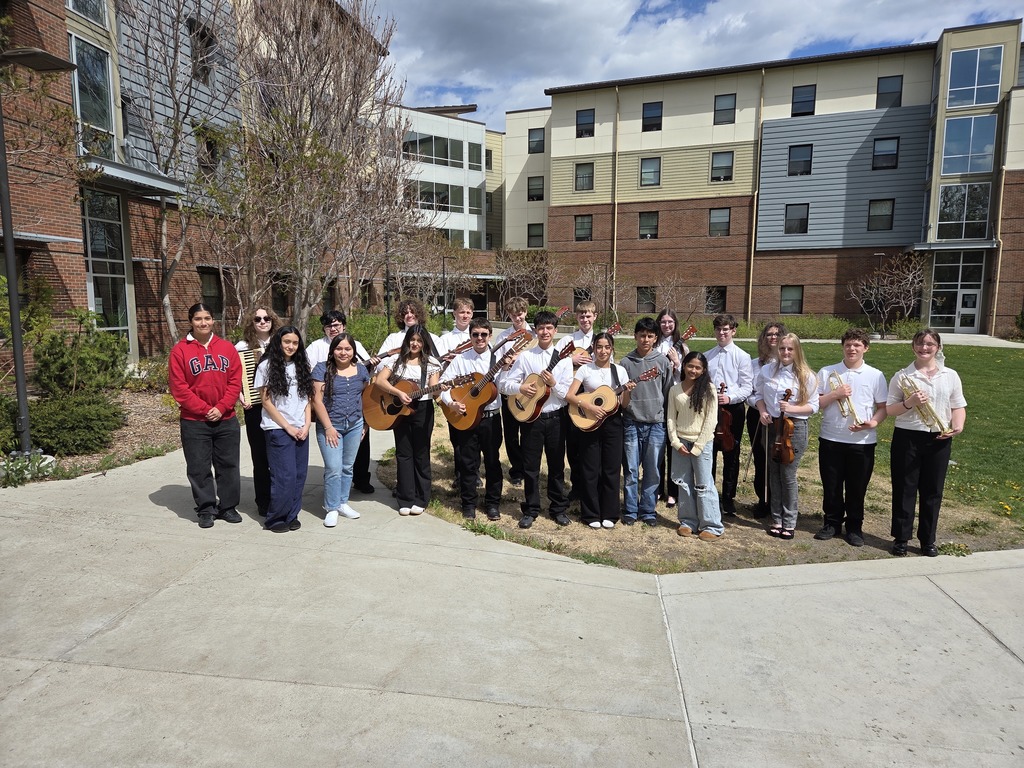 Sedro-Woolley High School mariachi students in performance attire at Central Washington University during the State Solo & Ensemble Music Competition, holding instruments and smiling together after their performance.