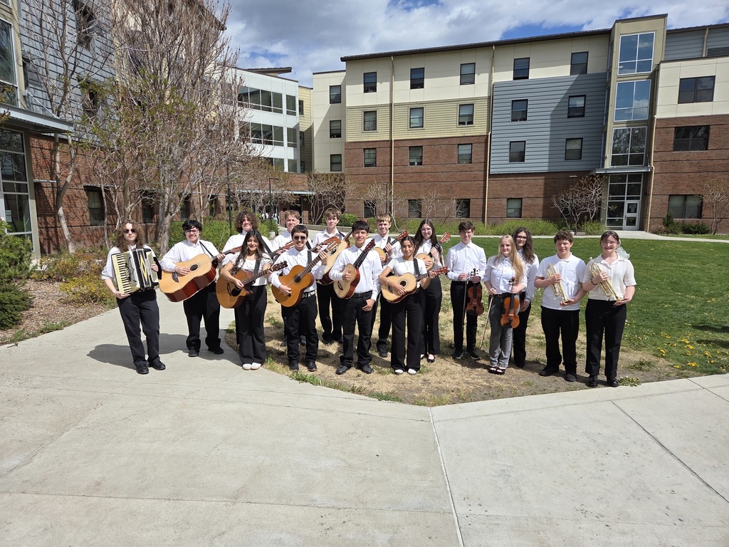 Sedro-Woolley High School mariachi students in performance attire at Central Washington University during the State Solo & Ensemble Music Competition, holding instruments and smiling together after their performance.