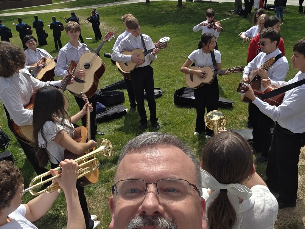 Sedro-Woolley High School mariachi students in performance attire at Central Washington University during the State Solo & Ensemble Music Competition, playing instruments and smiling together after their performance.