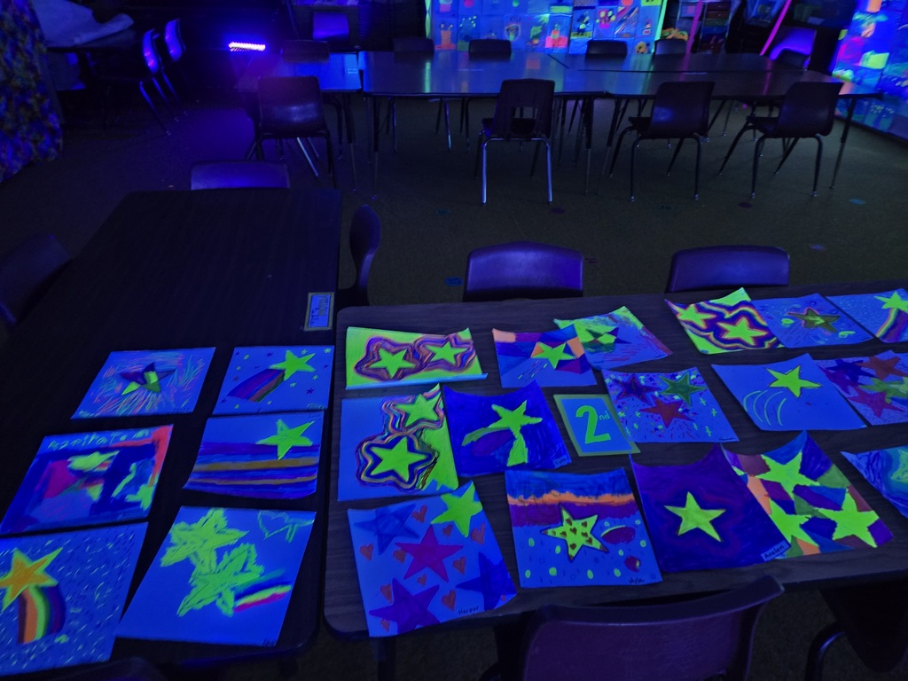 Students and families were able to explore glowing Vincent Van Gogh-inspired artwork during Evergreen STEM Elementary School’s art show and STEM Night. Displays feature colorful “Starry Night” and sunflower-themed student art illuminated under black lights.
