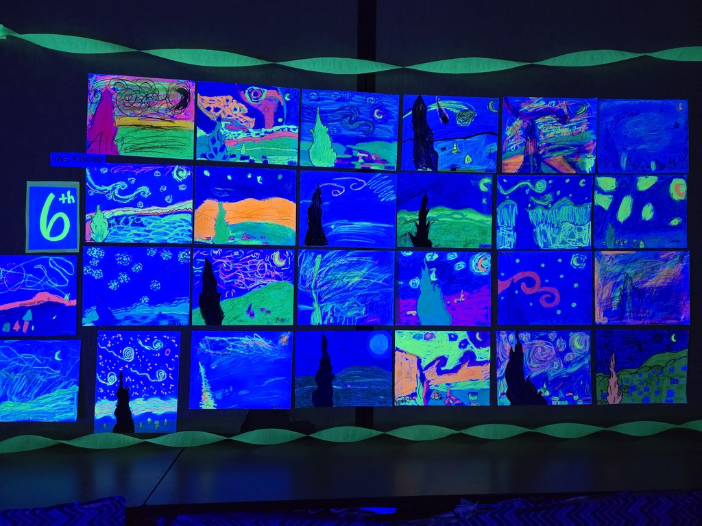 Students and families were able to explore glowing Vincent Van Gogh-inspired artwork during Evergreen STEM Elementary School’s art show and STEM Night. Displays feature colorful “Starry Night” and sunflower-themed student art illuminated under black lights.