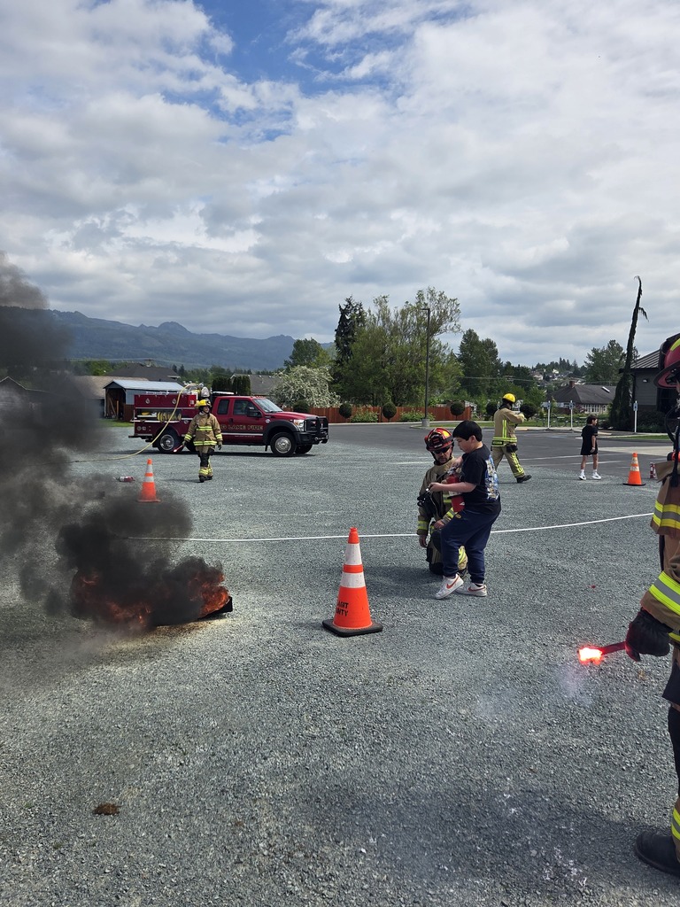Big Lake Elementary School 6th grade students visit the Big Lake Fire Department to learn about fire safety and practice using fire extinguishers with the help of local firefighters. Students participate in hands-on activities and demonstrations during the educational field trip.