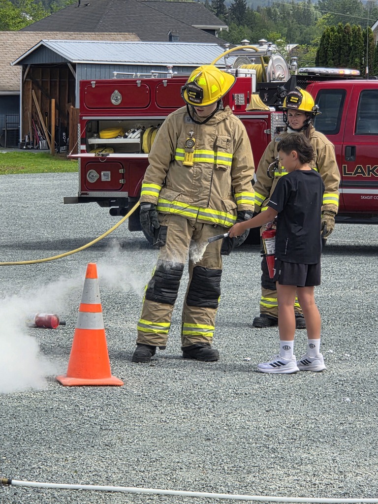 Big Lake Elementary School 6th grade students visit the Big Lake Fire Department to learn about fire safety and practice using fire extinguishers with the help of local firefighters. Students participate in hands-on activities and demonstrations during the educational field trip.