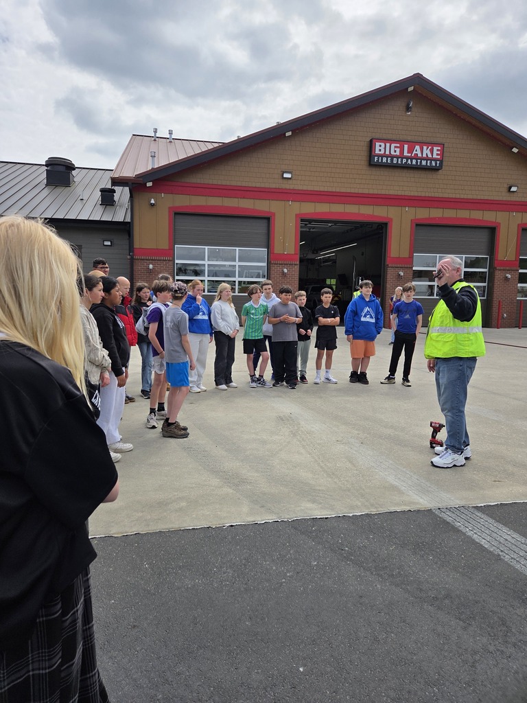 Big Lake Elementary School 6th grade students visit the Big Lake Fire Department to learn about fire safety and practice using fire extinguishers with the help of local firefighters. Students participate in hands-on activities and demonstrations during the educational field trip.
