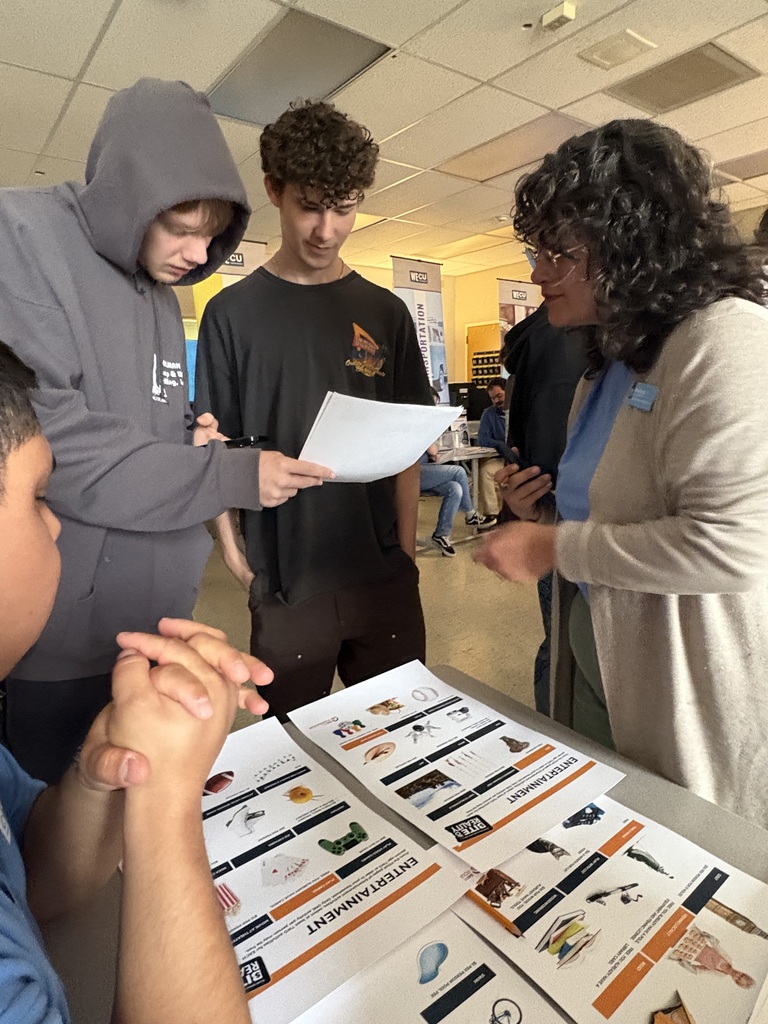 Sedro-Woolley High School students participate in the “Bite of Reality” financial simulation while speaking with WECU volunteers at different budgeting stations. Students review financial information, ask questions and make decisions about real-world expenses such as housing, transportation, groceries and childcare during the hands-on financial literacy activity.