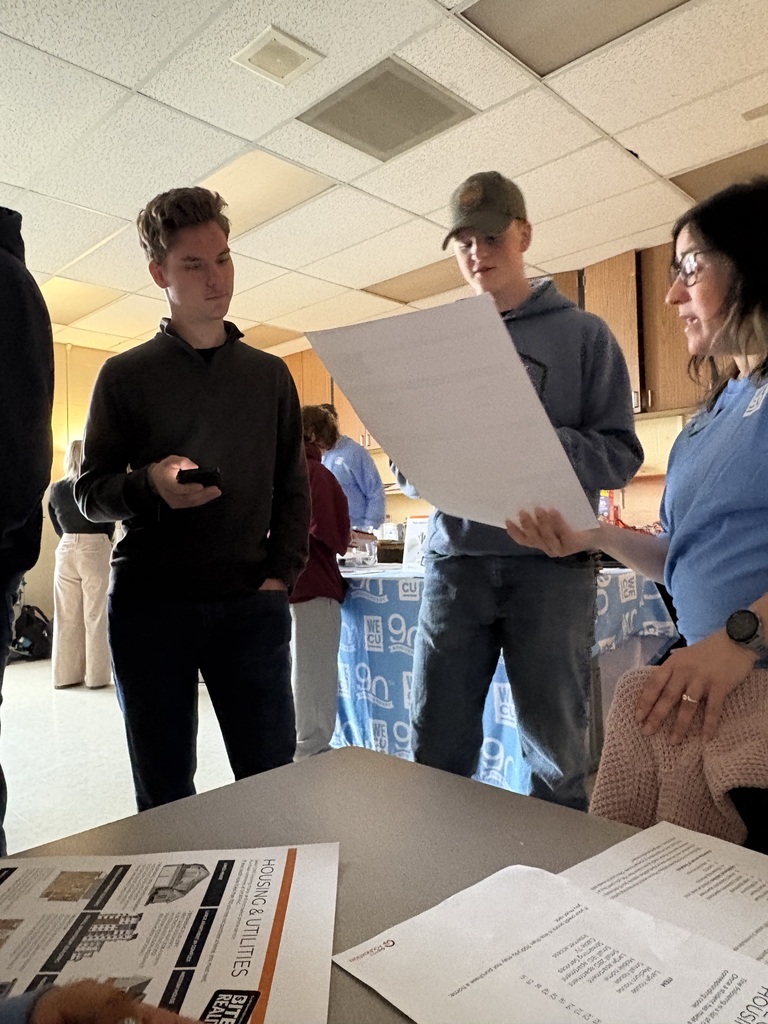 Sedro-Woolley High School students participate in the “Bite of Reality” financial simulation while speaking with WECU volunteers at different budgeting stations. Students review financial information, ask questions and make decisions about real-world expenses such as housing, transportation, groceries and childcare during the hands-on financial literacy activity.
