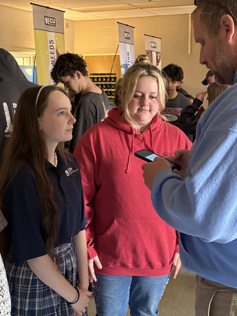 Sedro-Woolley High School students participate in the “Bite of Reality” financial simulation while speaking with WECU volunteers at different budgeting stations. Students review financial information, ask questions and make decisions about real-world expenses such as housing, transportation, groceries and childcare during the hands-on financial literacy activity.