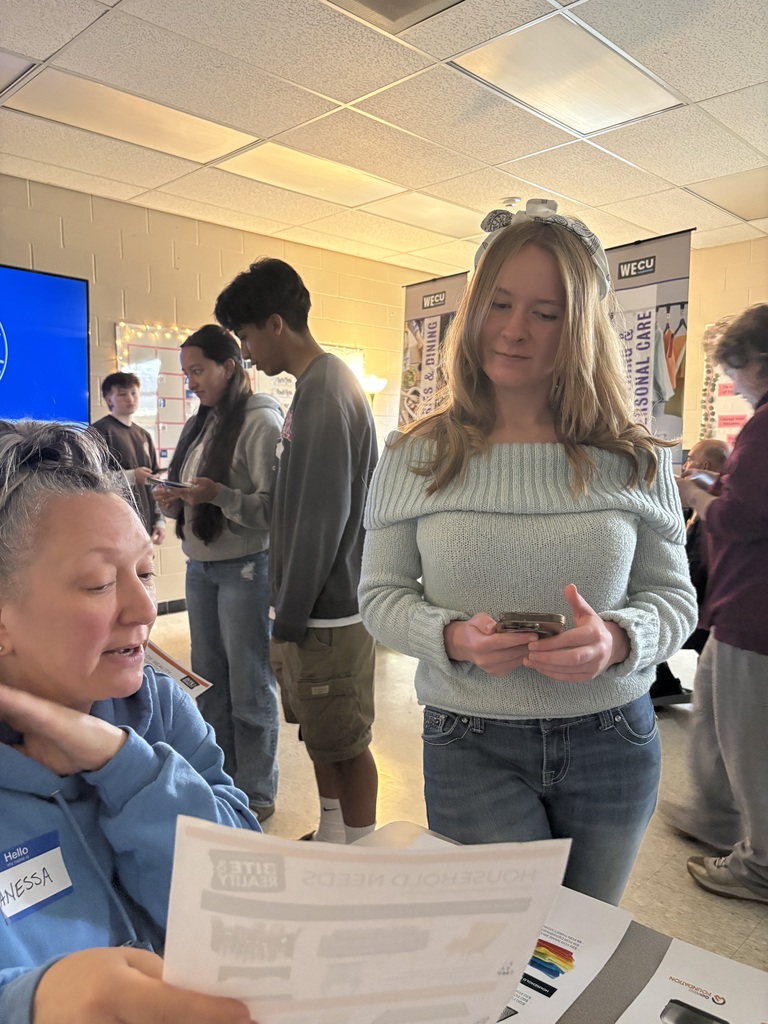Sedro-Woolley High School students participate in the “Bite of Reality” financial simulation while speaking with WECU volunteers at different budgeting stations. Students review financial information, ask questions and make decisions about real-world expenses such as housing, transportation, groceries and childcare during the hands-on financial literacy activity.