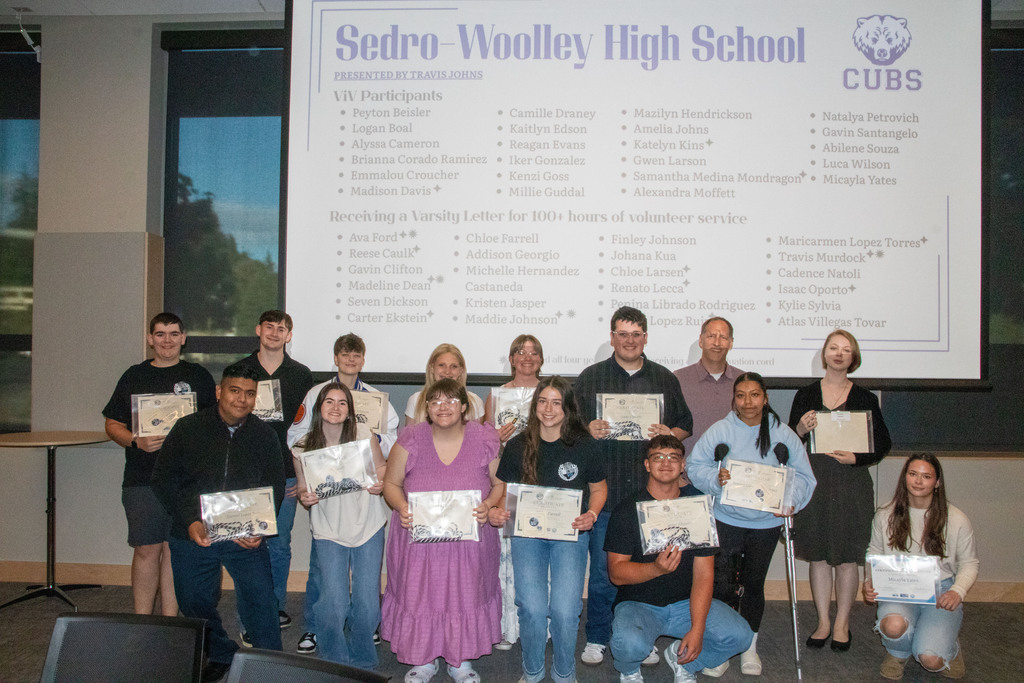 A group of Sedro-Woolley High School students and staff pose at the United General District 304 Central Celebration recognizing youth volunteer service. The students were honored for participating in the Varsity in Volunteerism program, contributing a combined 4,544 volunteer hours during the school year. Several students earned Varsity Letters in Volunteerism, and graduating seniors received honor cords recognizing their commitment to community service.