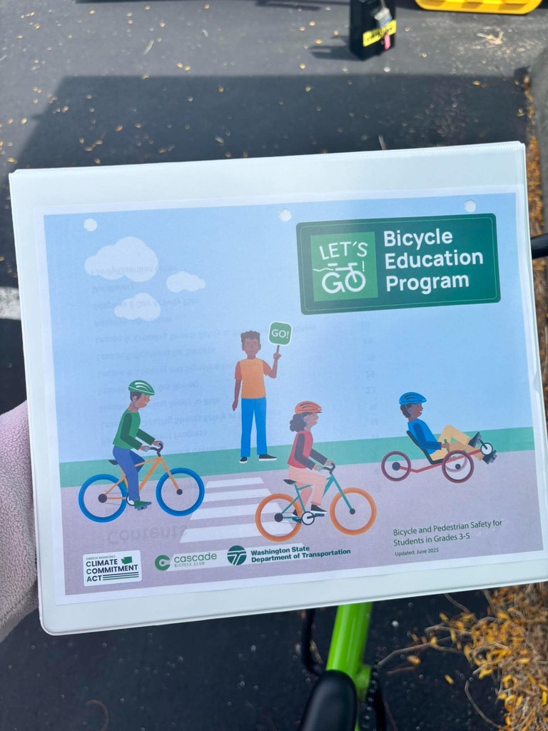 Bicycle Education Program training materials featuring illustrations of children riding bicycles and an adaptive cycle. The program teaches bicycle and pedestrian safety to students in grades 3–5.