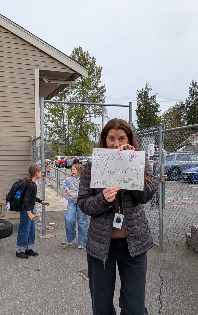 Big Lake Elementary staff welcome students during Surprise Attendance Day with music, bubbles, signs and cheers as students arrive at school.