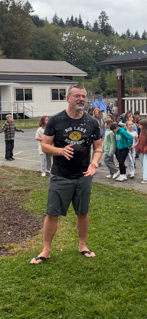 Big Lake Elementary students use water shooters to soak Principal Matt Lutes during the school’s first Surprise Attendance Day celebration.