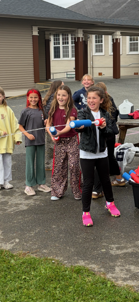 Big Lake Elementary students use water shooters to soak Principal Matt Lutes during the school’s first Surprise Attendance Day celebration.