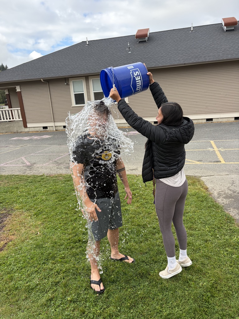 Big Lake Elementary students use water shooters to soak Principal Matt Lutes during the school’s first Surprise Attendance Day celebration.