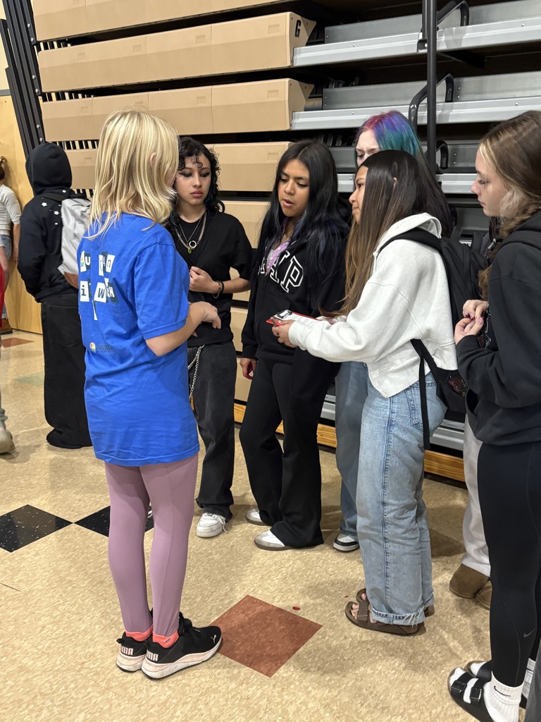 Cascade Middle School students participate in a Sources of Strength “You Belong” campaign during lunch. Students hold signed pledge sheets promoting encouragement, respect for different backgrounds and experiences, and a commitment to helping others feel that they belong in their school community.