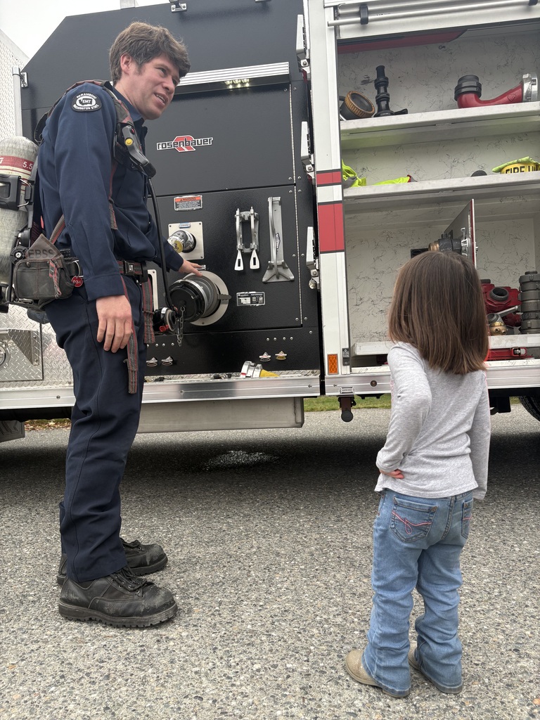 Photos show Good Beginnings Preschool students visiting with Sedro-Woolley firefighters and EMTs during Fire Prevention Week. Students explore a fire truck and ambulance, see emergency equipment up close and learn about fire safety and the work of local first responders.