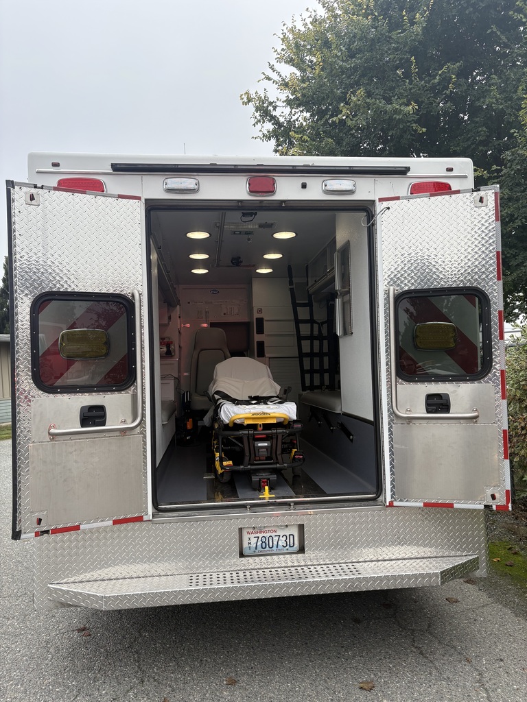 Photos show Good Beginnings Preschool students visiting with Sedro-Woolley firefighters and EMTs during Fire Prevention Week. Students explore a fire truck and ambulance, see emergency equipment up close and learn about fire safety and the work of local first responders.