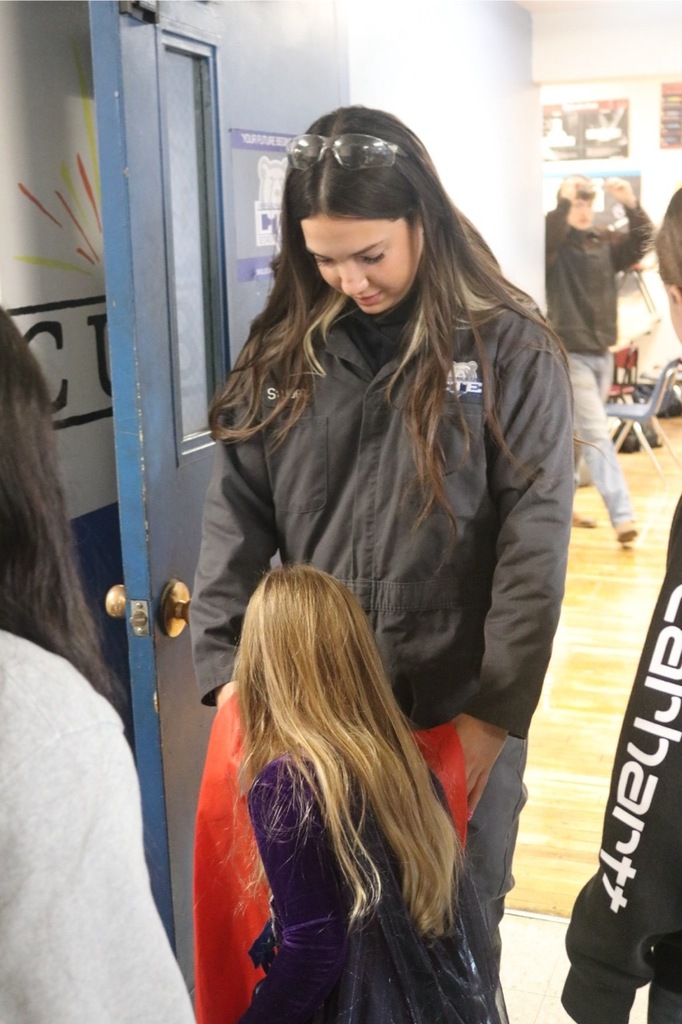 Preschool students from the Cubs Early Learning Academy, dressed in a variety of Halloween costumes, trick-or-treat through the hallways of Sedro-Woolley High School, visiting classrooms and collecting candy during a festive Halloween celebration.