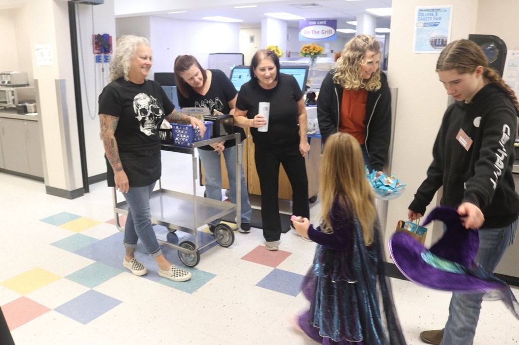 Preschool students from the Cubs Early Learning Academy, dressed in a variety of Halloween costumes, trick-or-treat through the hallways of Sedro-Woolley High School, visiting classrooms and collecting candy during a festive Halloween celebration.