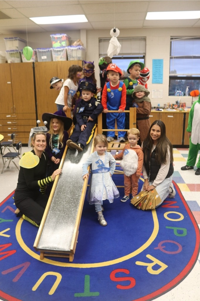 Preschool students from the Cubs Early Learning Academy, dressed in a variety of Halloween costumes, trick-or-treat through the hallways of Sedro-Woolley High School, visiting classrooms and collecting candy during a festive Halloween celebration.