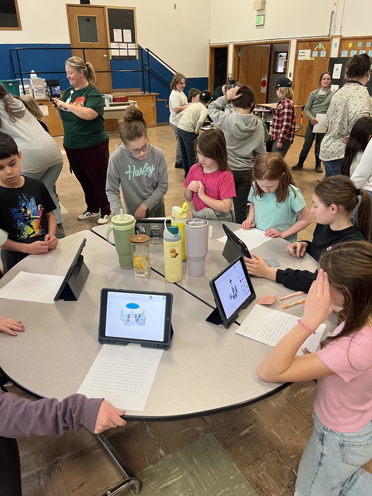 5th graders showing design work on iPads