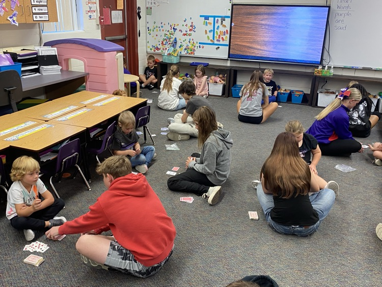 Eighth graders partnered with kindergarten today to learn a fun new card game that helps practice comparing bigger and smaller numbers.